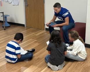 Football Players read to Igo Students